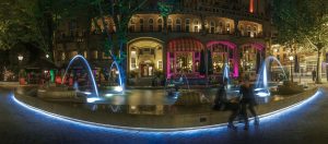 Beautiful fountain in front of the Hotel American, rendezvous, lovers, illuminated, colorful, Amsterdam, Netherlands