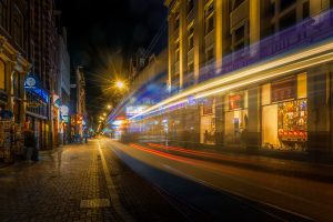 Shopping street Leidsestraat at night, a tram passing by, light streaks, Amsterdam, Netherlands