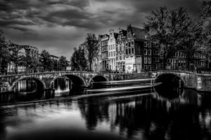 Famous spot of the two bridges at Keizersgracht and Herengracht, painterly black and white version, Amsterdam, Netherlands