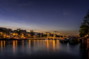 Famous bridge over the river Amstel, the Magere brug, skinny bridge, beautliful at blue hour, Amsterdam, Netherlands