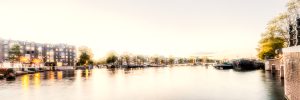Panorama image of river Amstel and illuminated houses, Amsterdam, Netherlands, white, artistic, painterly