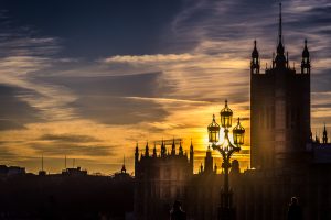 The sun going down right behind an old lantern at the Houses of Parliament in London, London, Great Britain,